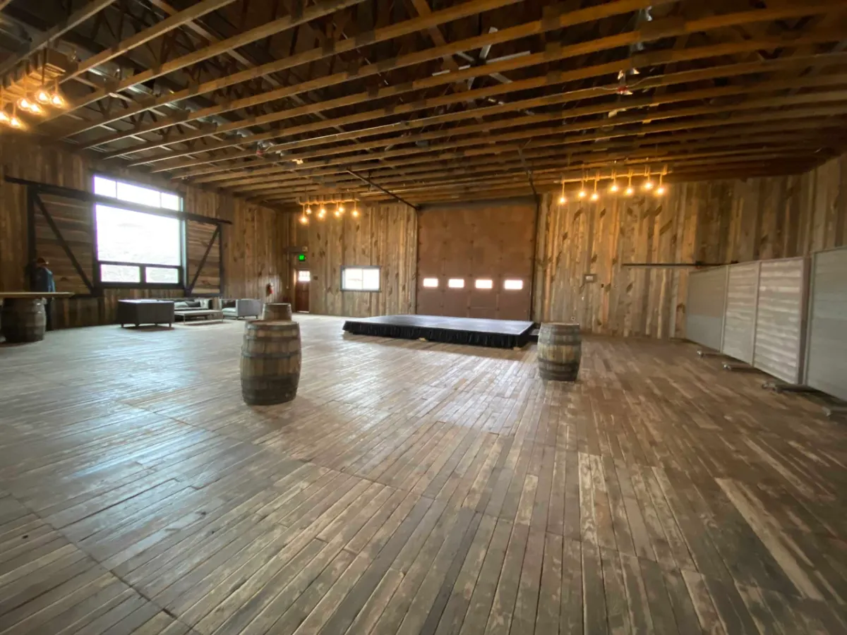 Wide view of the empty timber barn with the stage deck in place