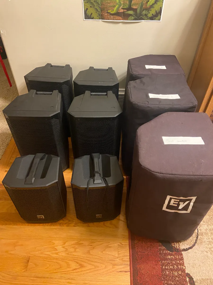 Electro-Voice powered speakers and subwoofers cased and stacked ready for delivery