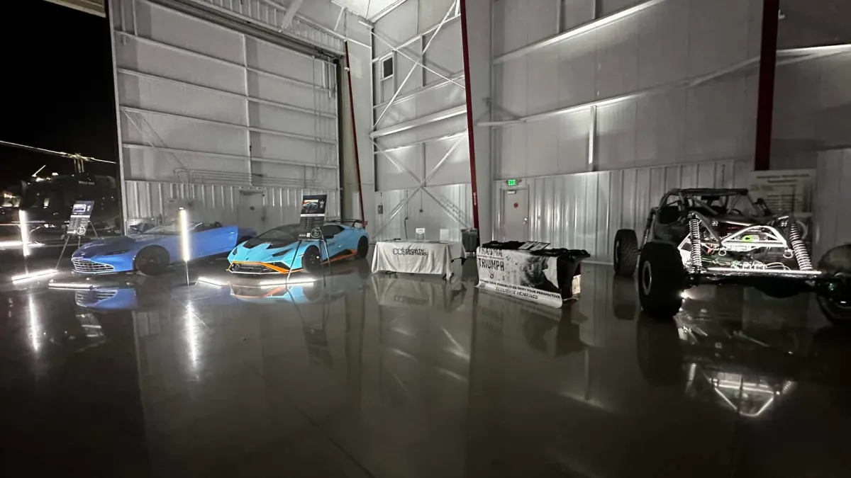 Hangar interior with vehicles uplit along both walls