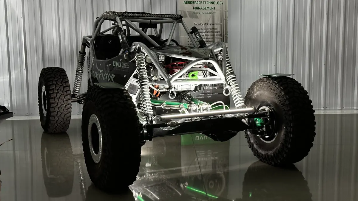 Off-road race buggy picked out by white and green lighting