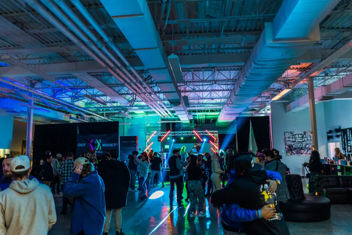 Crowd watching a live band under stage lighting