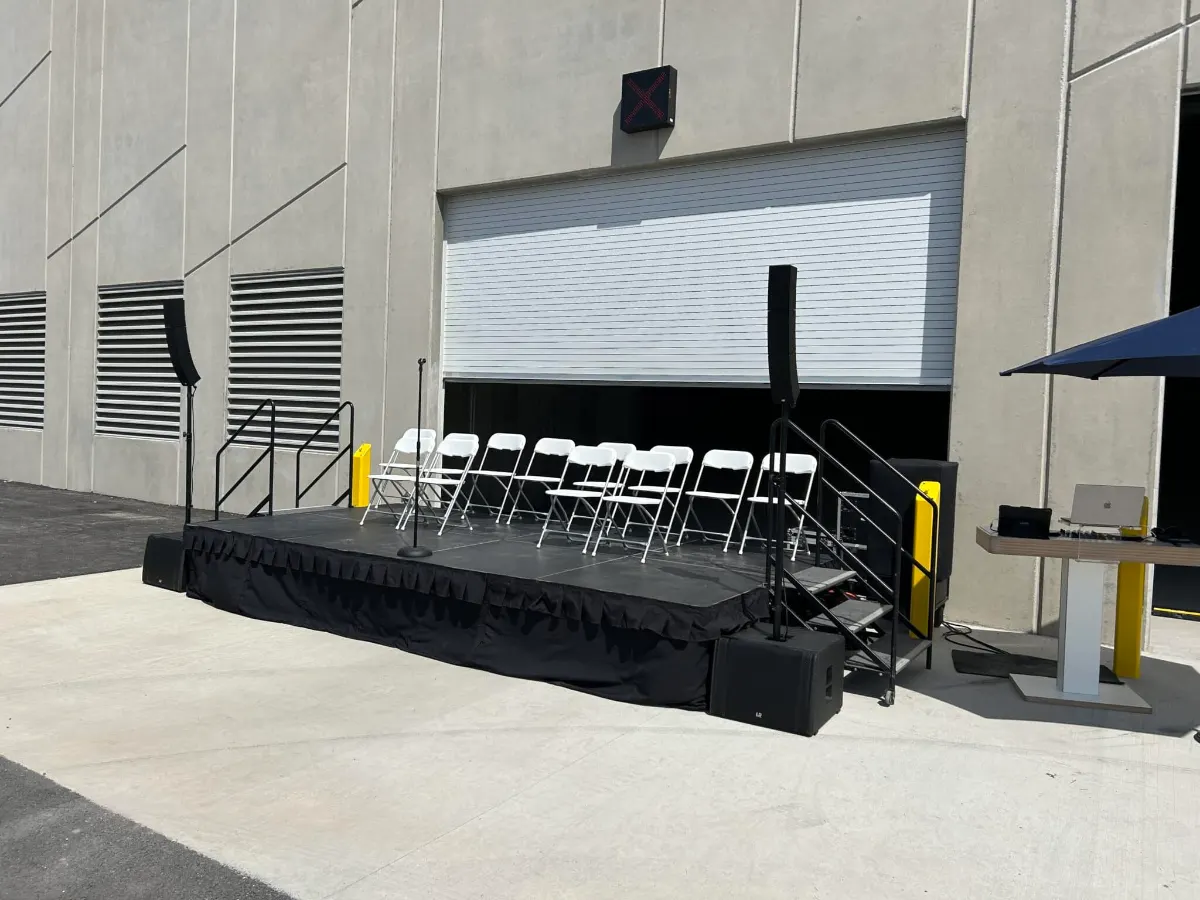 Stage deck with stairs and seating set up outside the transfer station building