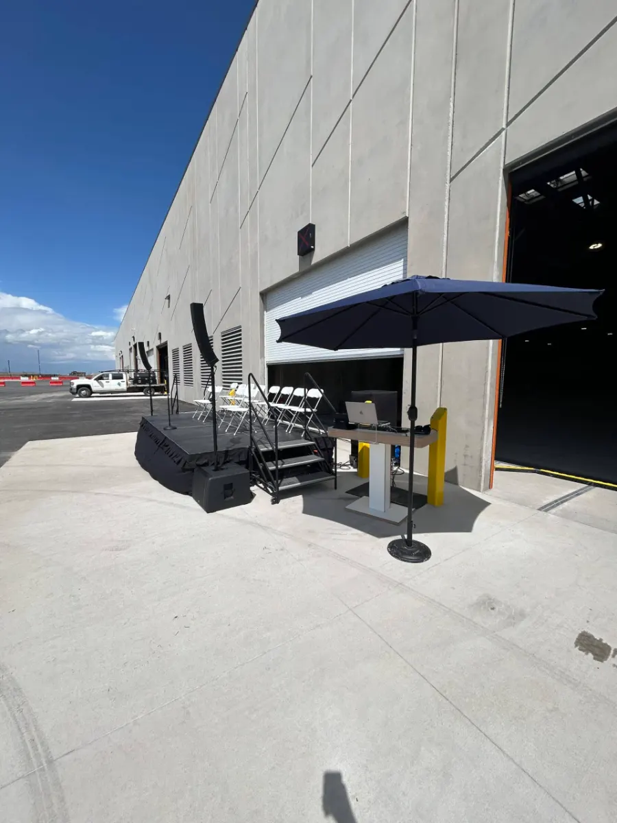Stage and canopy from the side against the concrete building