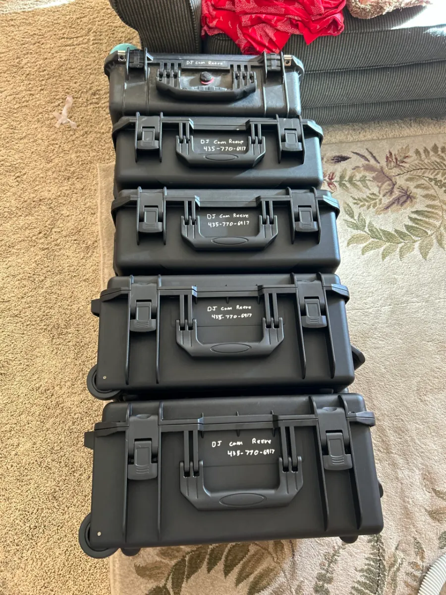 Row of hard cases packed with DJ equipment ready for delivery