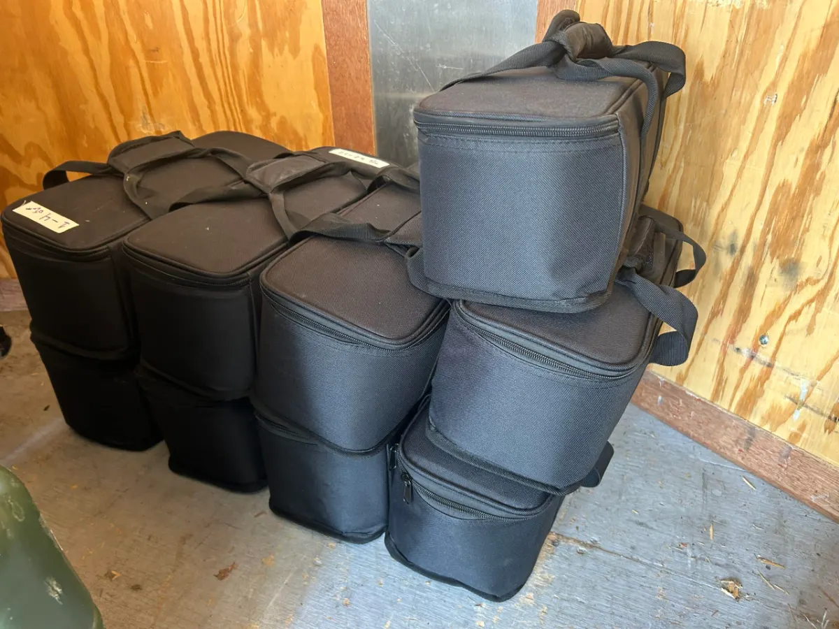 Padded speaker and subwoofer bags stacked and ready to load