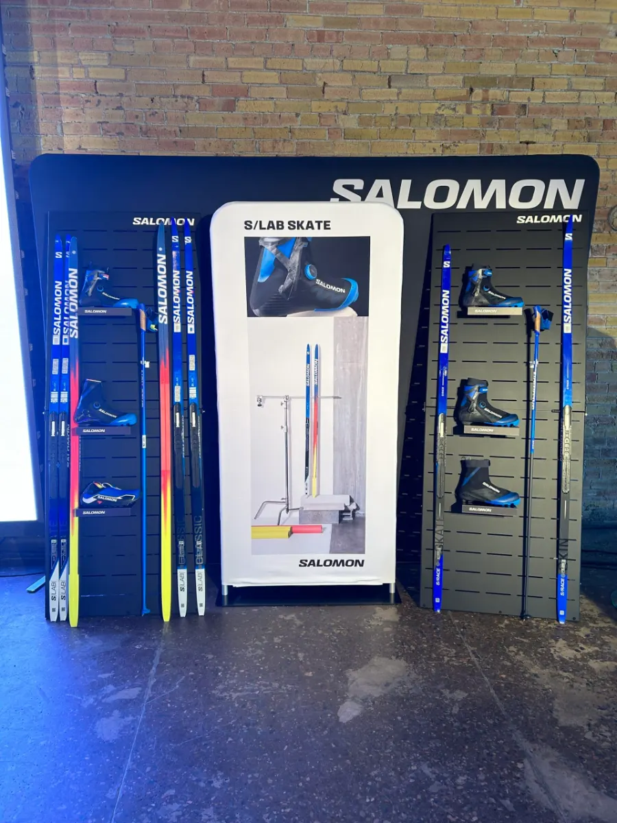 Product display wall of skis and equipment set up for a corporate product launch and training event