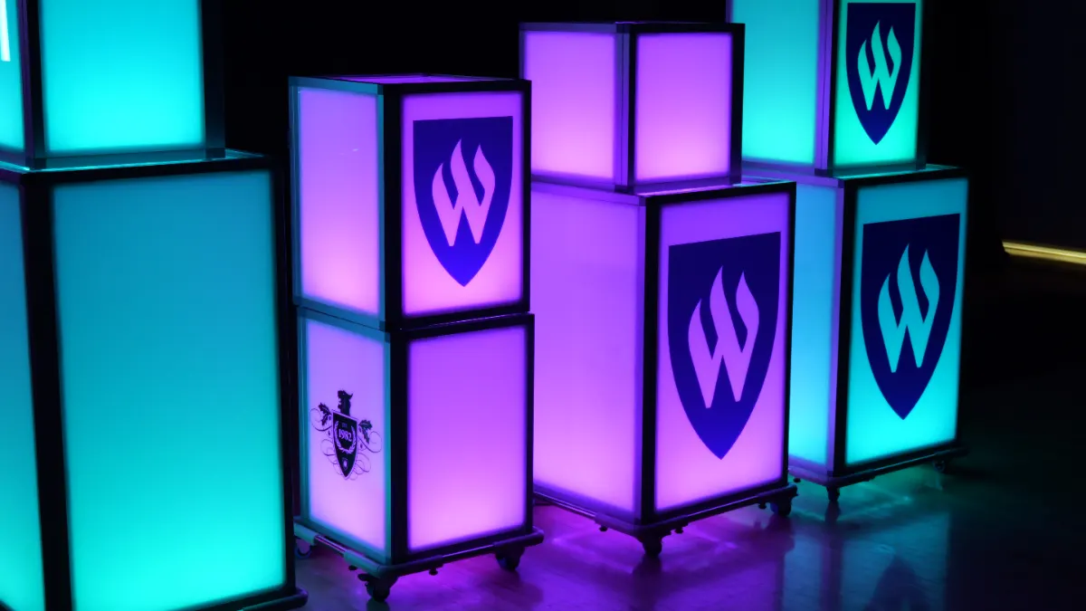 Glow tubes and Weber State branded light boxes across the stage front