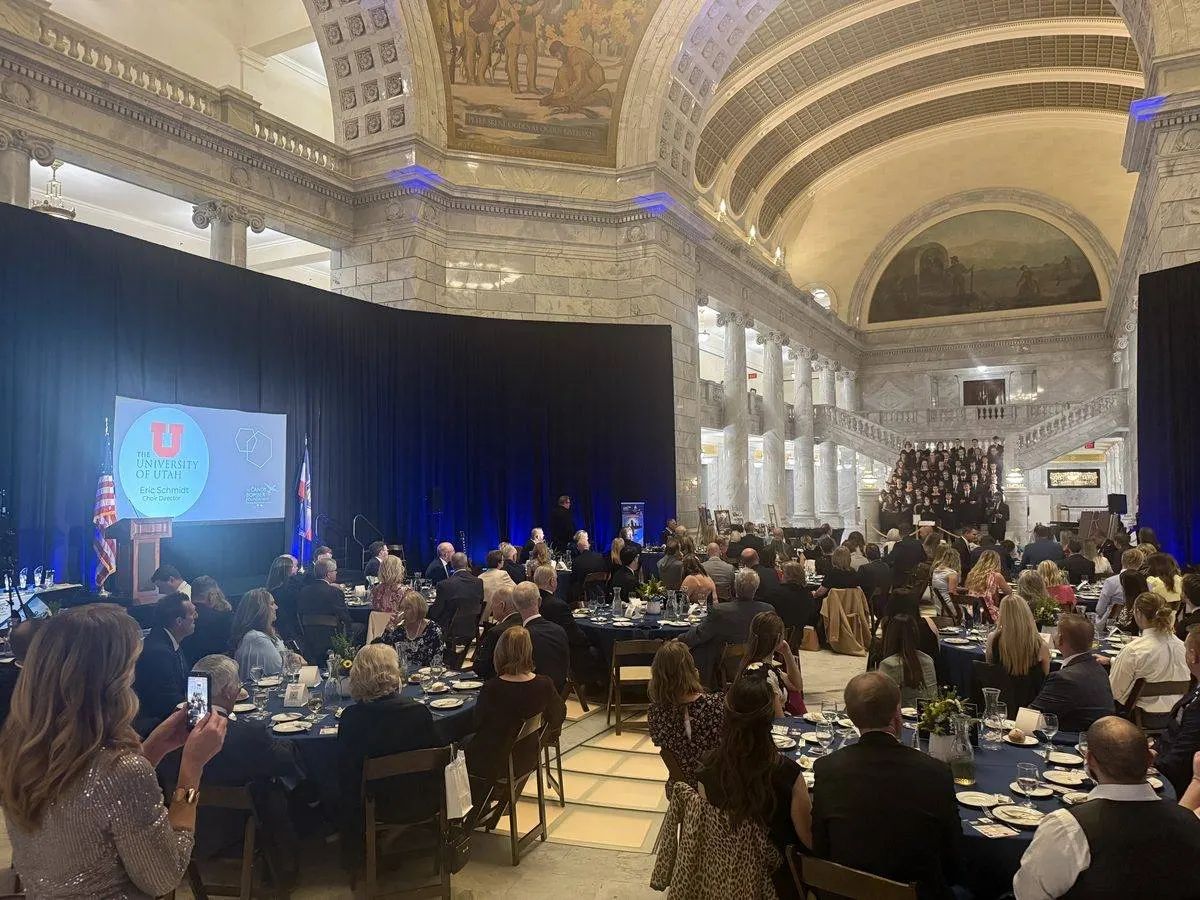 Gala with stage, screen, and round tables inside the Utah State Capitol rotunda