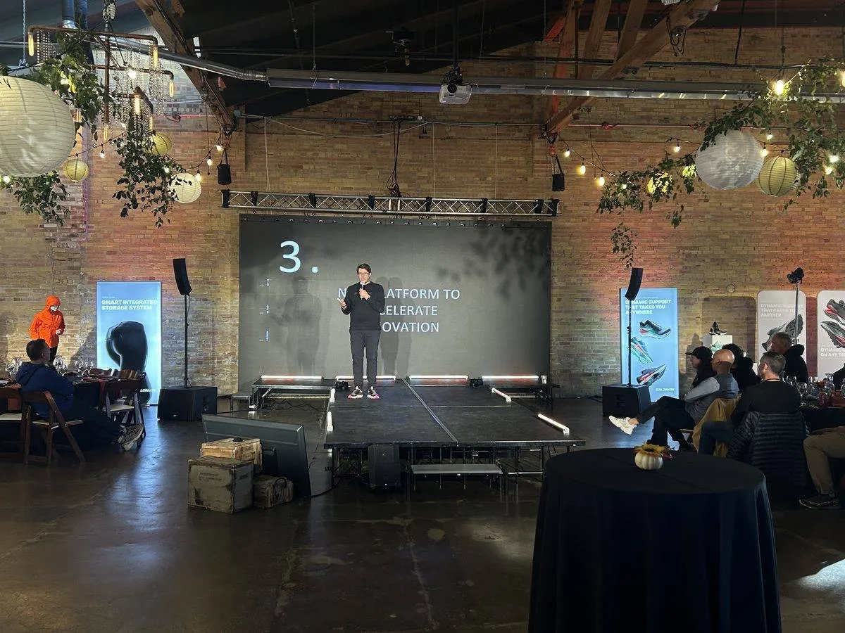 Presenter on stage with a projection screen and a downstage confidence monitor