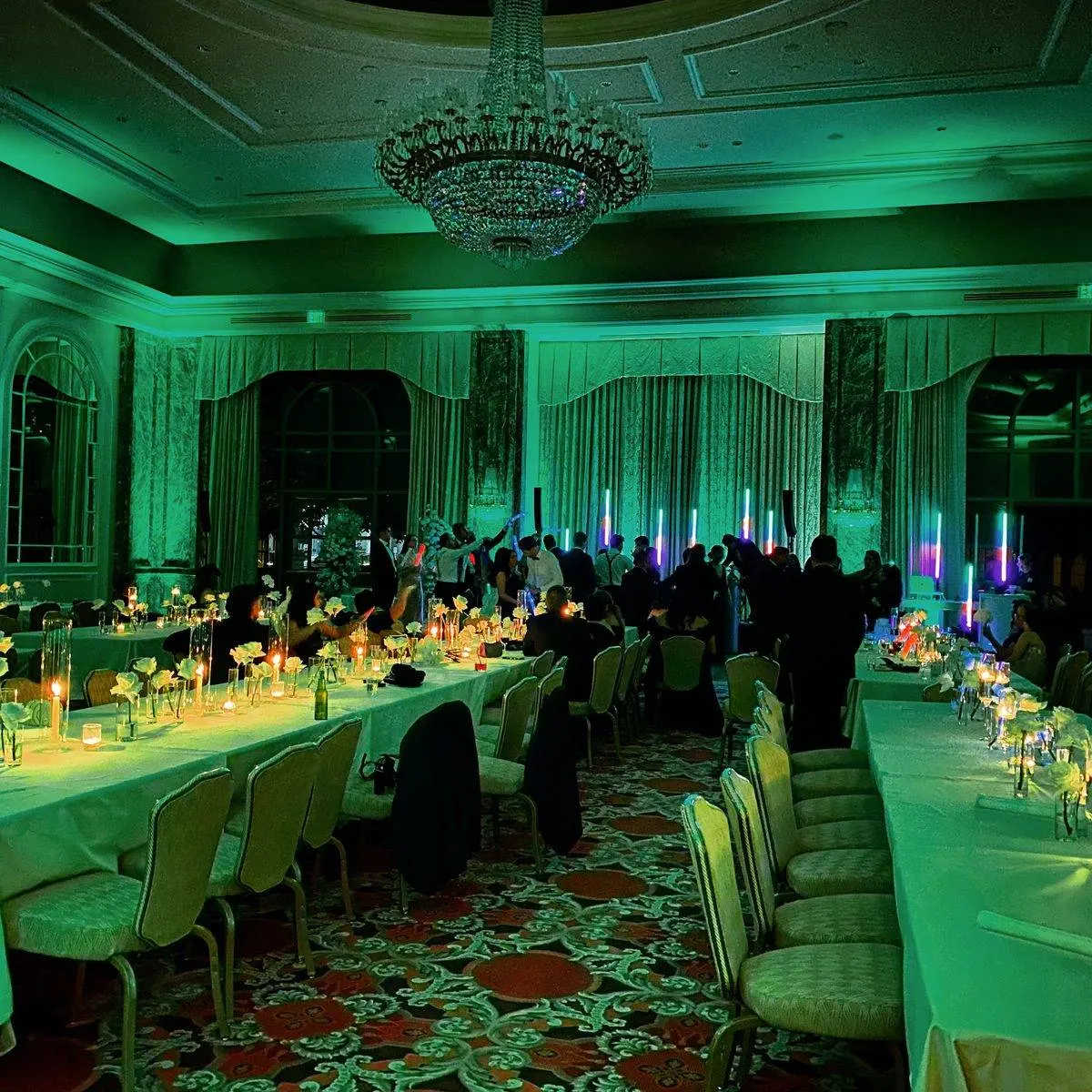 Grand America ballroom transformed with green uplighting for a corporate event