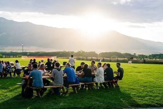 Golden hour dinner on a lawn with mountain views